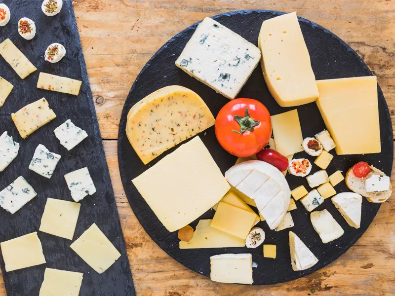 What are the benefits of adding calcium chloride in cheese production?